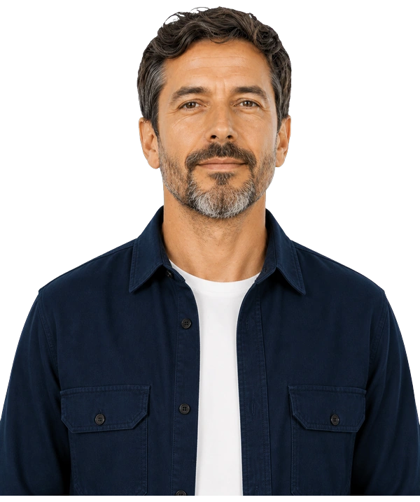 A man with a greying beard in a navy overshirt, looking calmly ahead.
